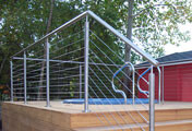 Stainless steel balustrade with tubular upright posts with cable infill